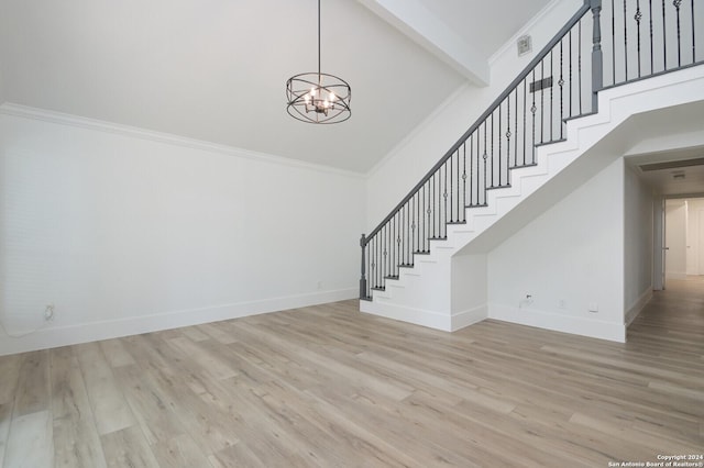 stairs with hardwood / wood-style floors, a notable chandelier, crown molding, and beamed ceiling