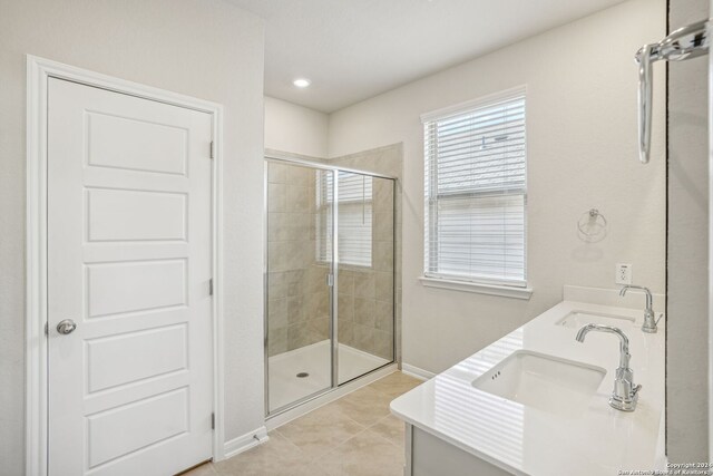 bathroom featuring vanity, an enclosed shower, and tile patterned floors