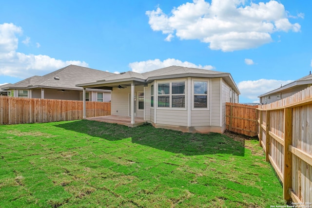 rear view of house with a lawn, a patio area, and ceiling fan