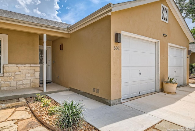 view of exterior entry with a garage