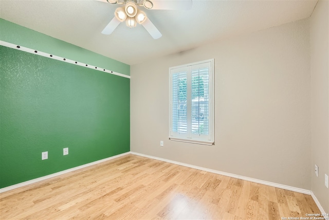 empty room featuring hardwood / wood-style flooring and ceiling fan