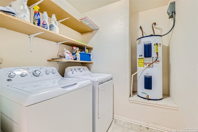 clothes washing area with washer and dryer and water heater