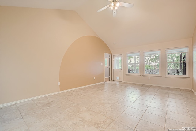 unfurnished room featuring vaulted ceiling, light tile patterned floors, and ceiling fan