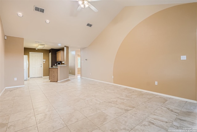 unfurnished living room with vaulted ceiling and ceiling fan