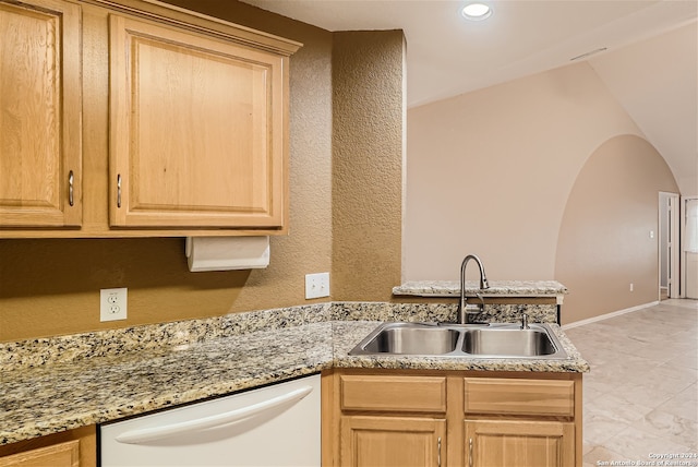 kitchen featuring dishwasher, sink, light stone countertops, and light brown cabinets