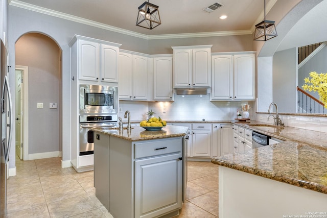 kitchen featuring light stone countertops, white cabinetry, and stainless steel appliances