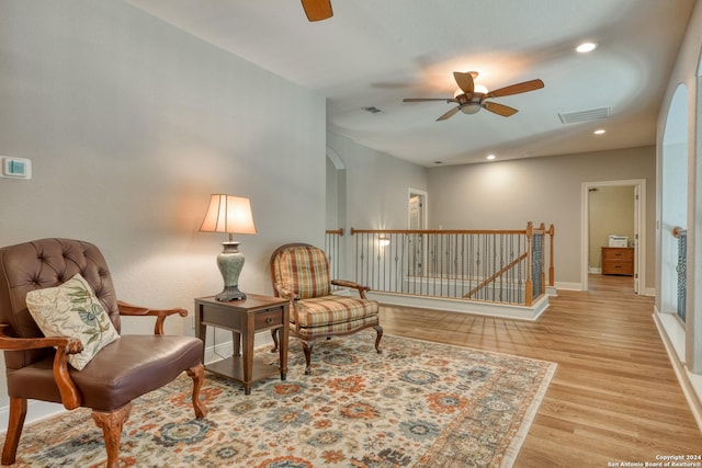 sitting room with ceiling fan and light hardwood / wood-style floors