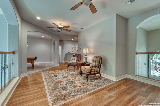 living area featuring ceiling fan, light hardwood / wood-style floors, and billiards