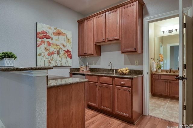 kitchen with sink and light wood-type flooring