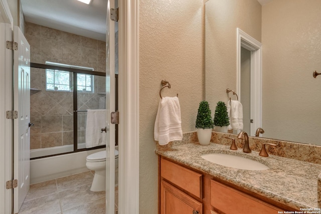 full bathroom featuring vanity, enclosed tub / shower combo, and toilet