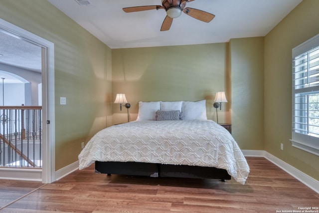 bedroom featuring ceiling fan and hardwood / wood-style flooring