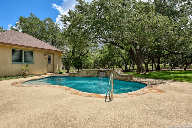 view of pool featuring pool water feature and a patio