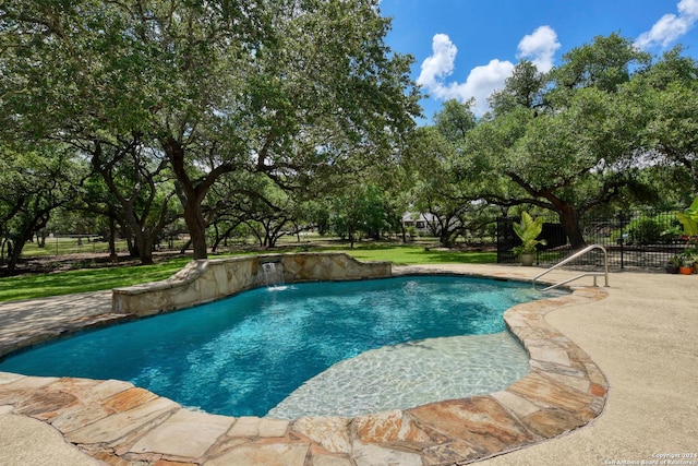 view of swimming pool with a patio area and pool water feature