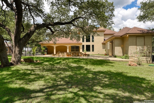 back of property featuring a yard