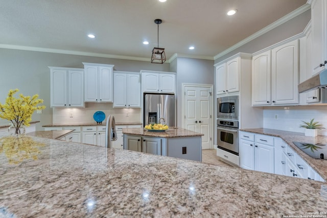 kitchen featuring a center island, pendant lighting, white cabinets, and stainless steel appliances