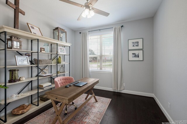 home office with dark hardwood / wood-style flooring and ceiling fan