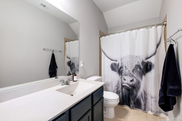 bathroom with tile patterned flooring, vanity, toilet, and lofted ceiling