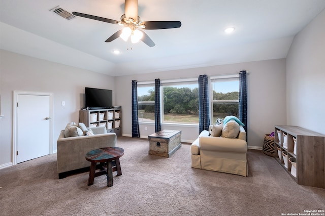 living room featuring carpet flooring, ceiling fan, and lofted ceiling