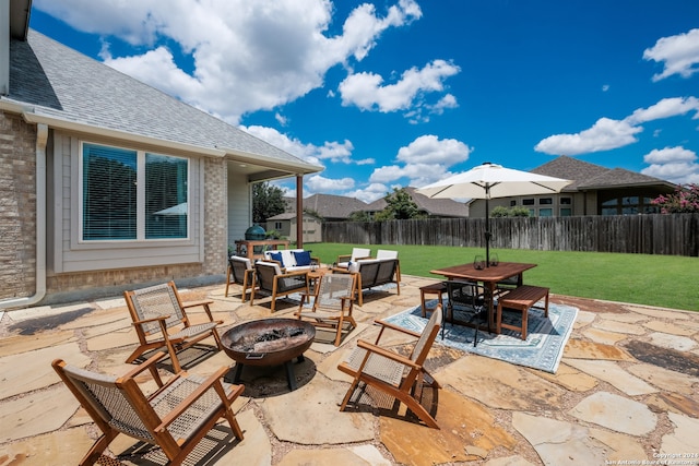 view of patio with an outdoor living space with a fire pit