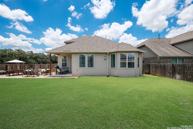 back of house featuring a yard and a patio area