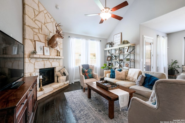 living room featuring a stone fireplace, ceiling fan, dark hardwood / wood-style flooring, and high vaulted ceiling