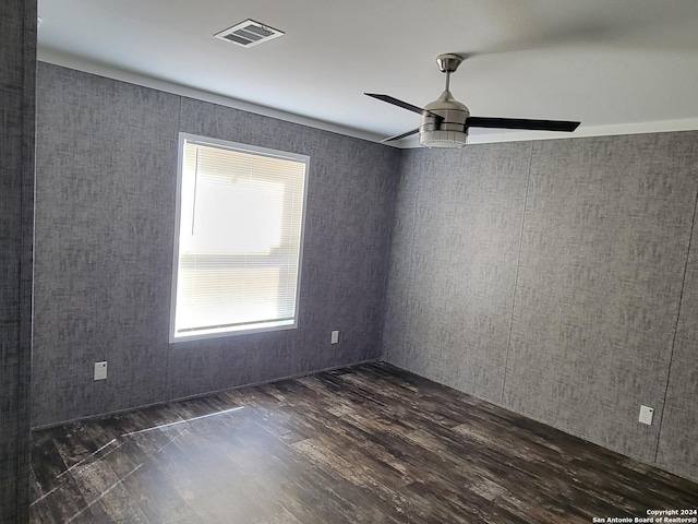 spare room featuring ceiling fan and dark wood-type flooring