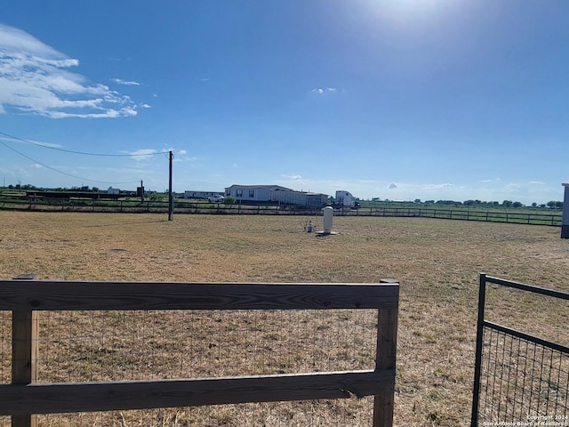 view of yard with a rural view