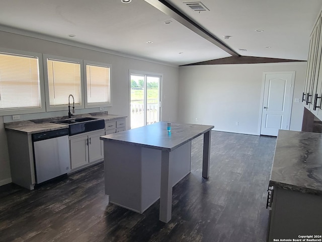 kitchen with dishwasher, white cabinets, sink, a kitchen island, and dark hardwood / wood-style flooring