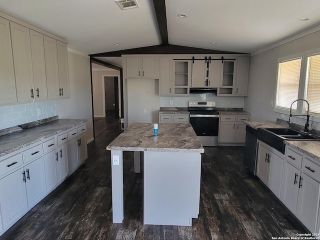 kitchen featuring sink, electric stove, lofted ceiling with beams, a center island, and white cabinetry