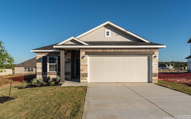 3569 Alto Stratus, New Braunfels, TX 78130 - view of front of property featuring fence, a garage, driveway, stone siding, and a front yard