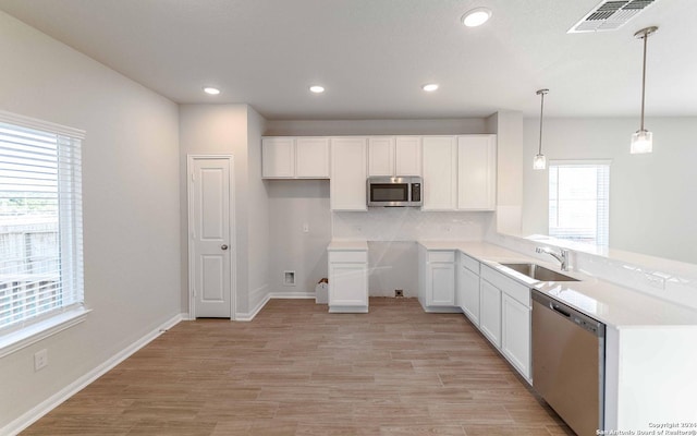 3569 Alto Stratus, New Braunfels, TX 78130 - kitchen with recessed lighting, appliances with stainless steel finishes, white cabinets, a sink, and visible vents