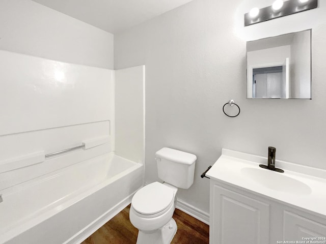 full bathroom featuring vanity, hardwood / wood-style floors, toilet, and washtub / shower combination