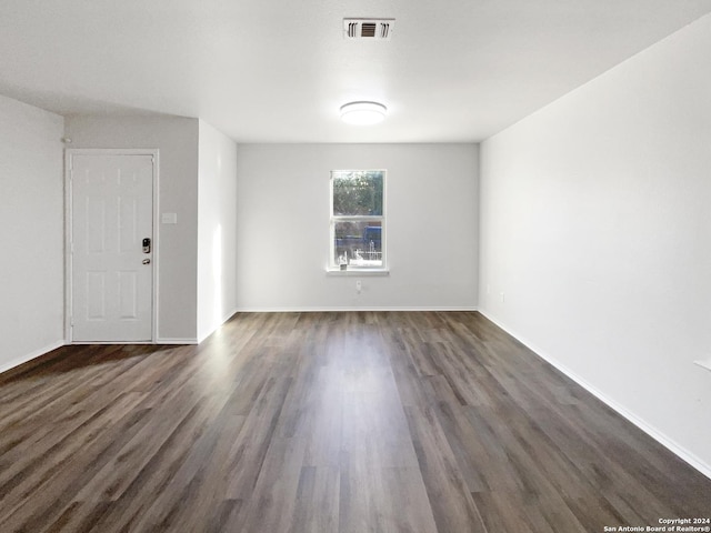 spare room with dark hardwood / wood-style floors