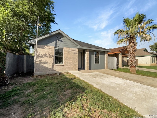 ranch-style house with a front lawn