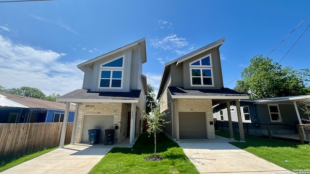 contemporary home featuring a garage and a front lawn