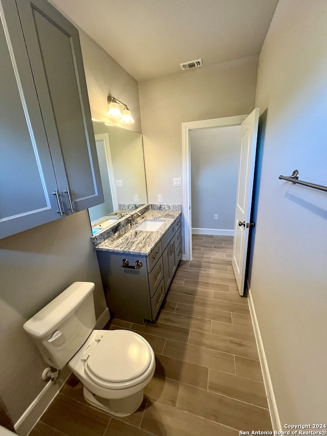 bathroom with toilet and vanity