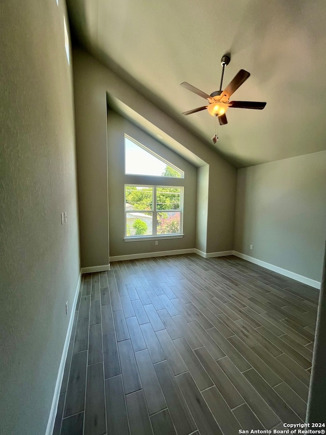 spare room featuring dark hardwood / wood-style flooring, ceiling fan, and lofted ceiling