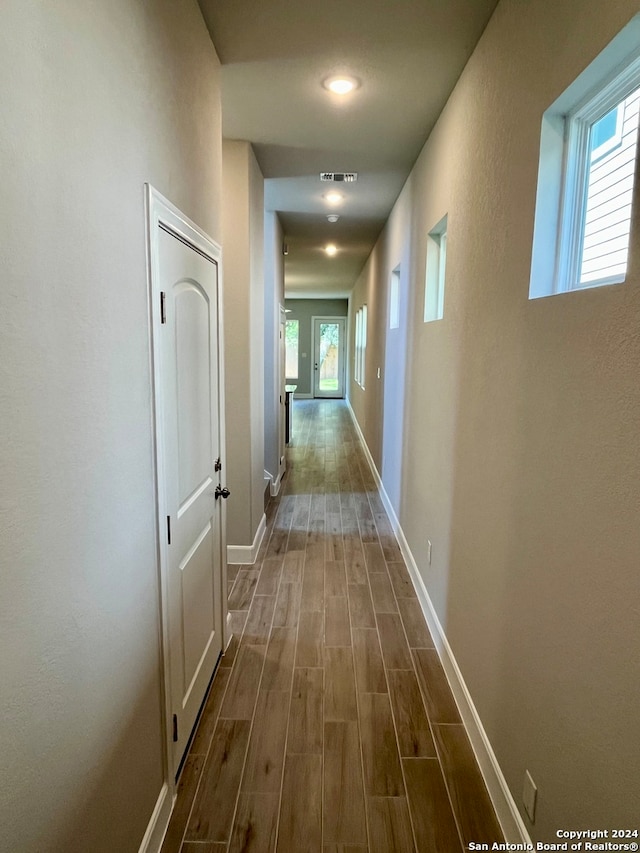 corridor featuring dark wood-type flooring