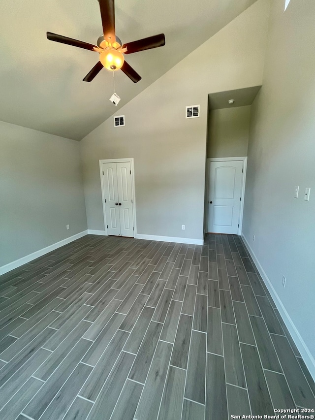 spare room with high vaulted ceiling, ceiling fan, and dark hardwood / wood-style flooring