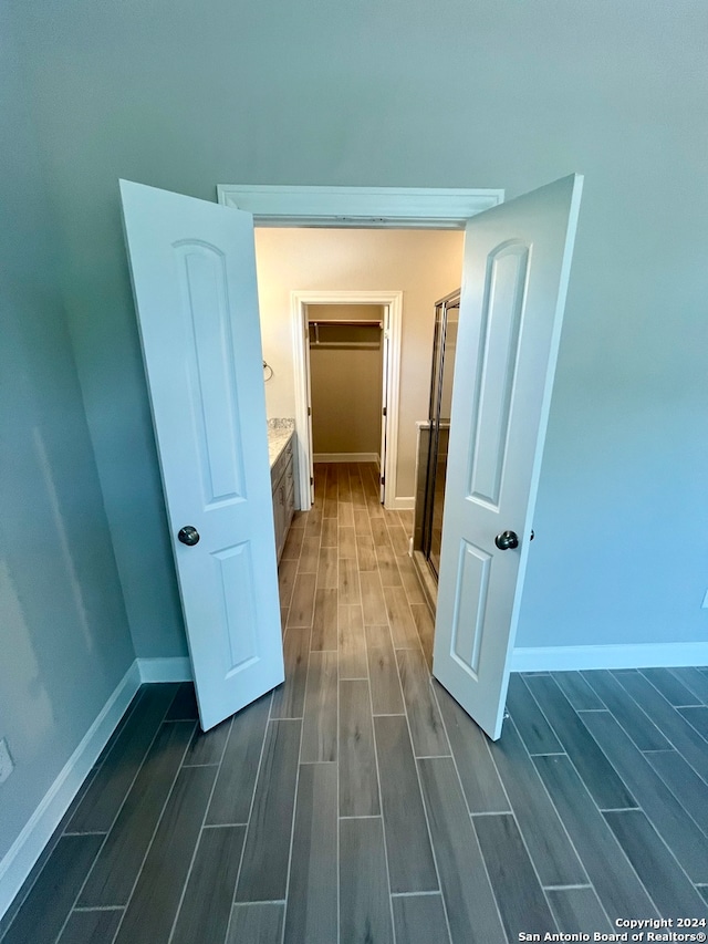 hallway with dark hardwood / wood-style floors