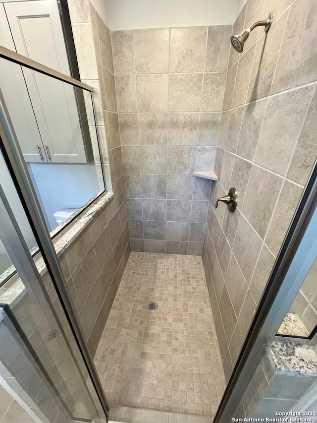 bathroom with tiled shower