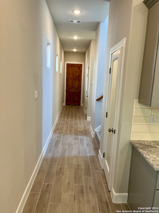 hallway with wood-type flooring