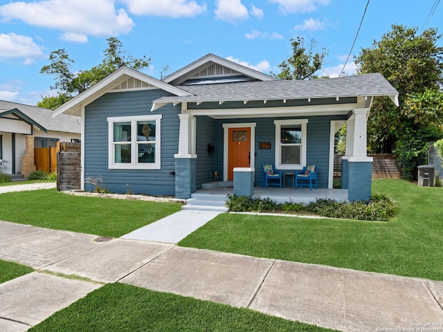 bungalow-style house featuring a porch and a front yard