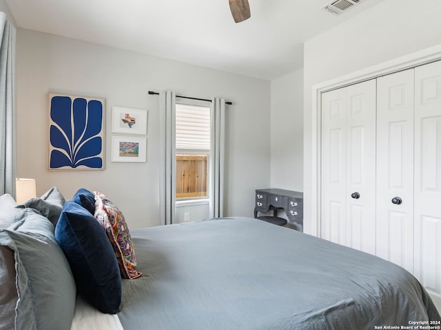 bedroom with ceiling fan and a closet