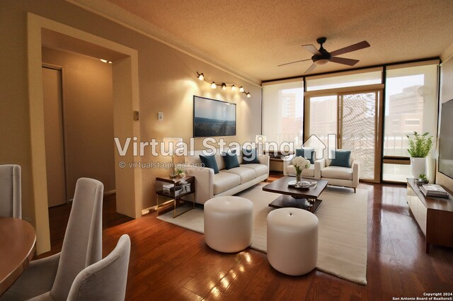 living room with hardwood / wood-style flooring, a wall of windows, ceiling fan, and a textured ceiling