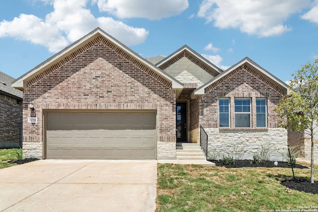 view of front facade featuring driveway, an attached garage, and brick siding