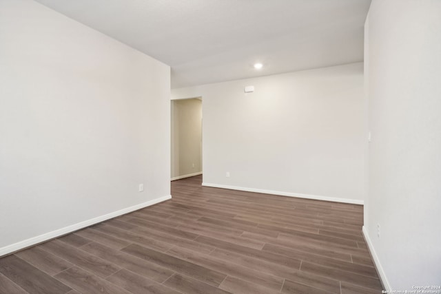 unfurnished room with dark wood-style floors, recessed lighting, and baseboards