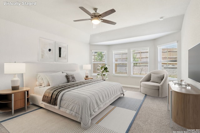 bedroom featuring light carpet, ceiling fan, and baseboards