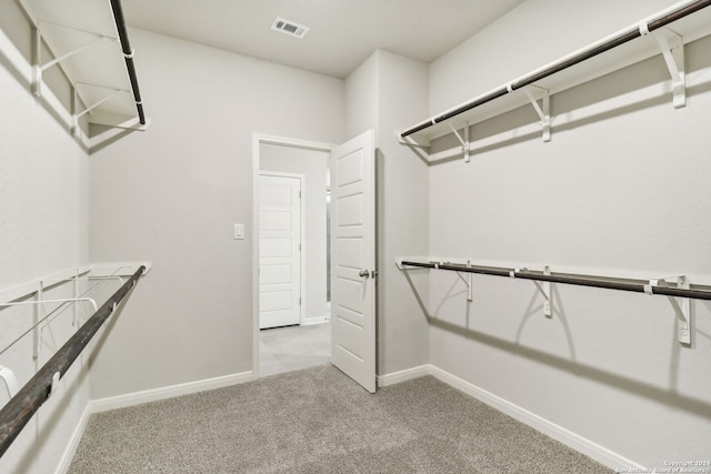 walk in closet with light carpet and visible vents