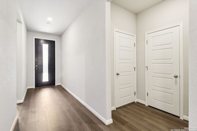 entryway featuring dark wood-style flooring and baseboards